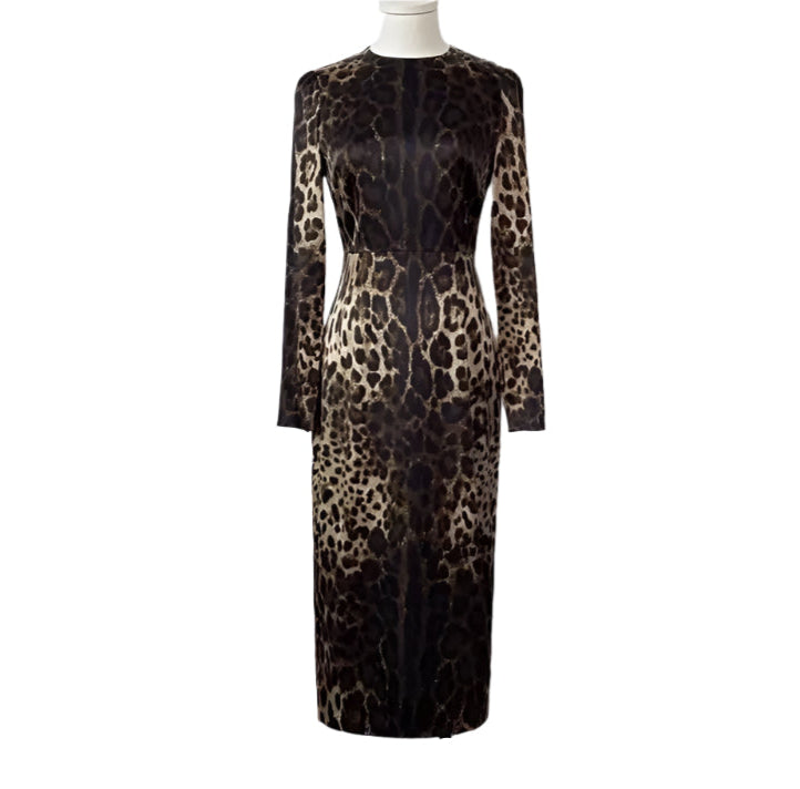A long sleeve midi silk dress with a leopard print pattern in a neutral color palette, fully lined, with a visible zipper at the back.