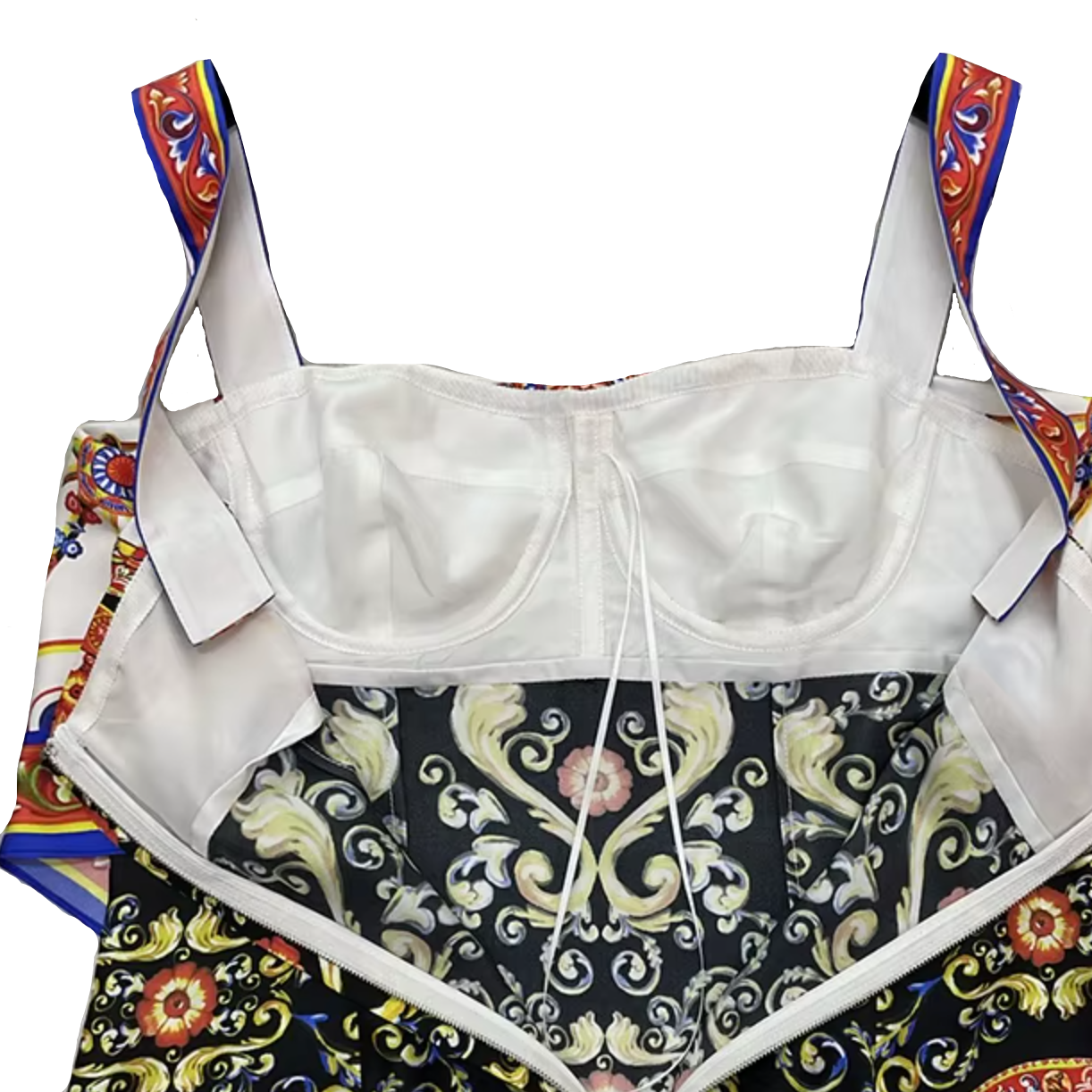A cropped fashion garment laid flat on a hanger against a light gray marble-patterned background. The top portion is a solid white bustier-style underwire bra, while the lower portion features a black background with ornate gold baroque scrollwork and multicolored floral motifs in red, blue, and orange.