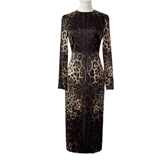 A long sleeve midi silk dress with a leopard print pattern in a neutral color palette, fully lined, with a visible zipper at the back.