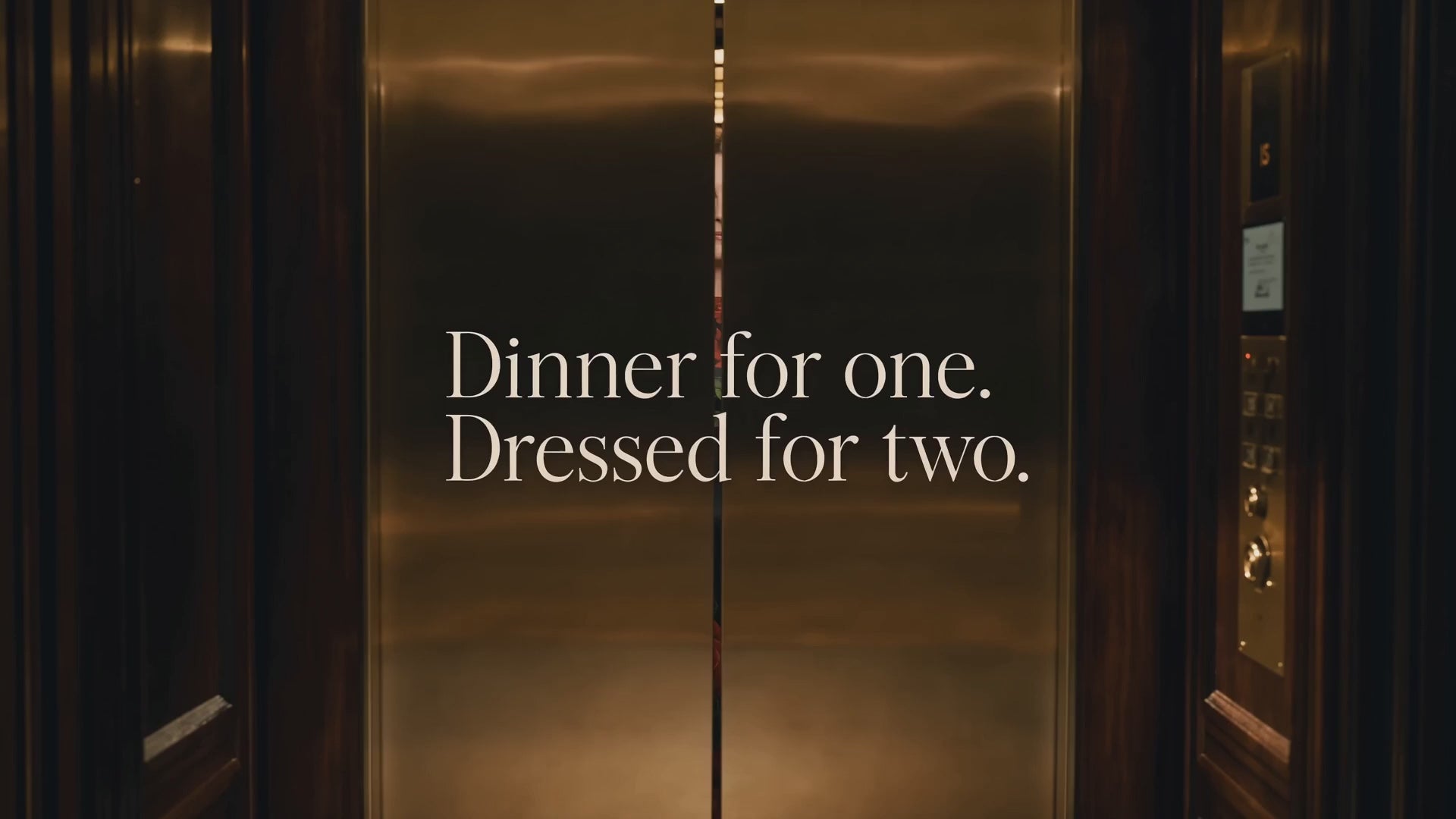 Load video: woman midi silk roses print dress exits the elevator of luxury hotel for romantic evening at the  restaurant